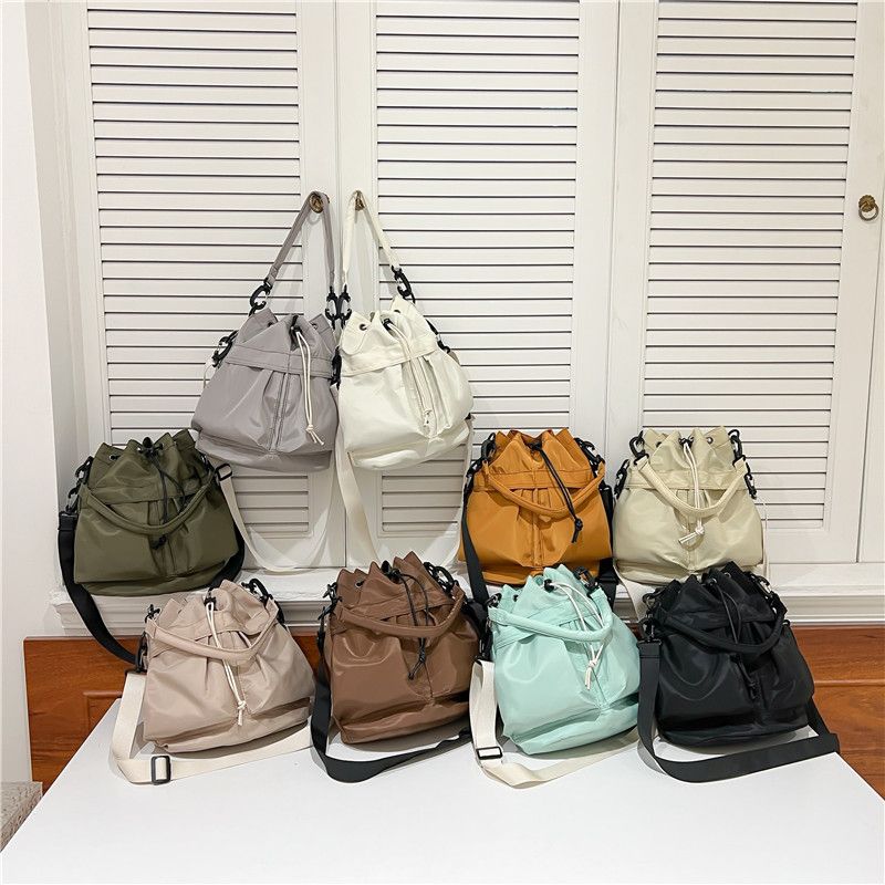 Women's Nylon Solid Color Preppy Style Classic Style Sports Cross Straps Sewing Thread Bucket String Crossbody Bag