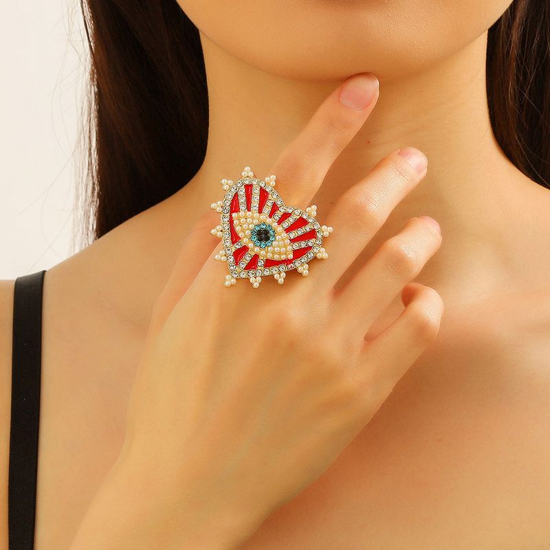 Großhandel Schmuck Strassenmode Herzform Auge Legierung Künstliche Perlen Künstlicher Diamant Inlay Offener Ring