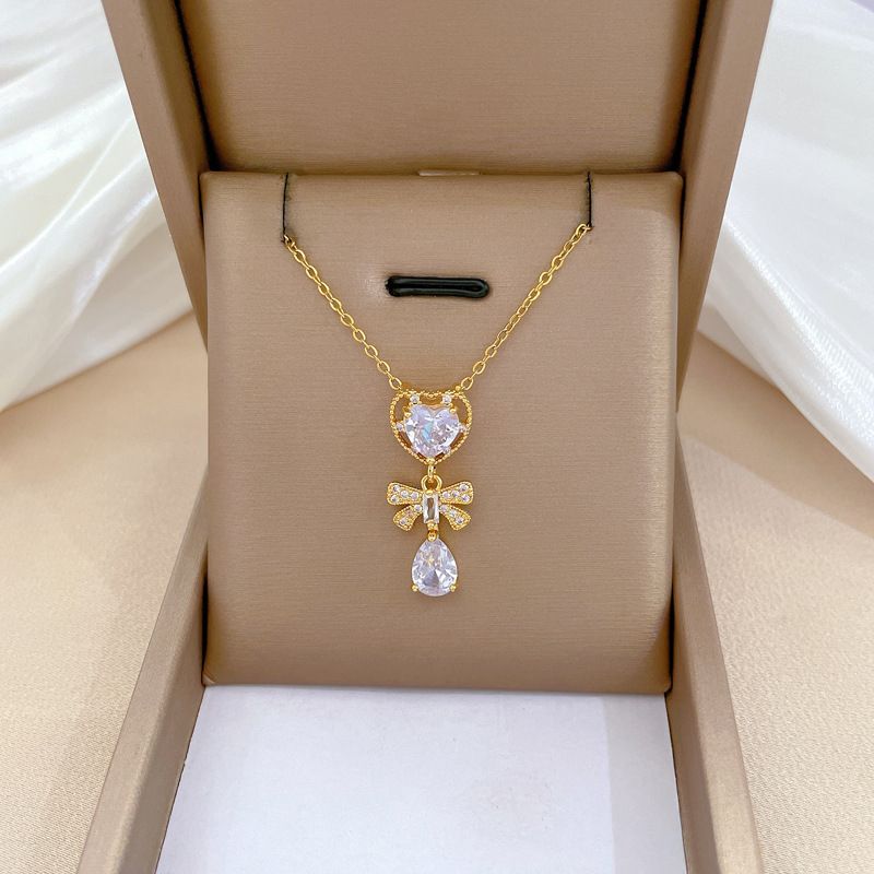 Wholesale Modern Style Commute Heart Shape Bow Knot Titanium Steel Copper Plating Inlay Artificial Gemstones Pendant Necklace