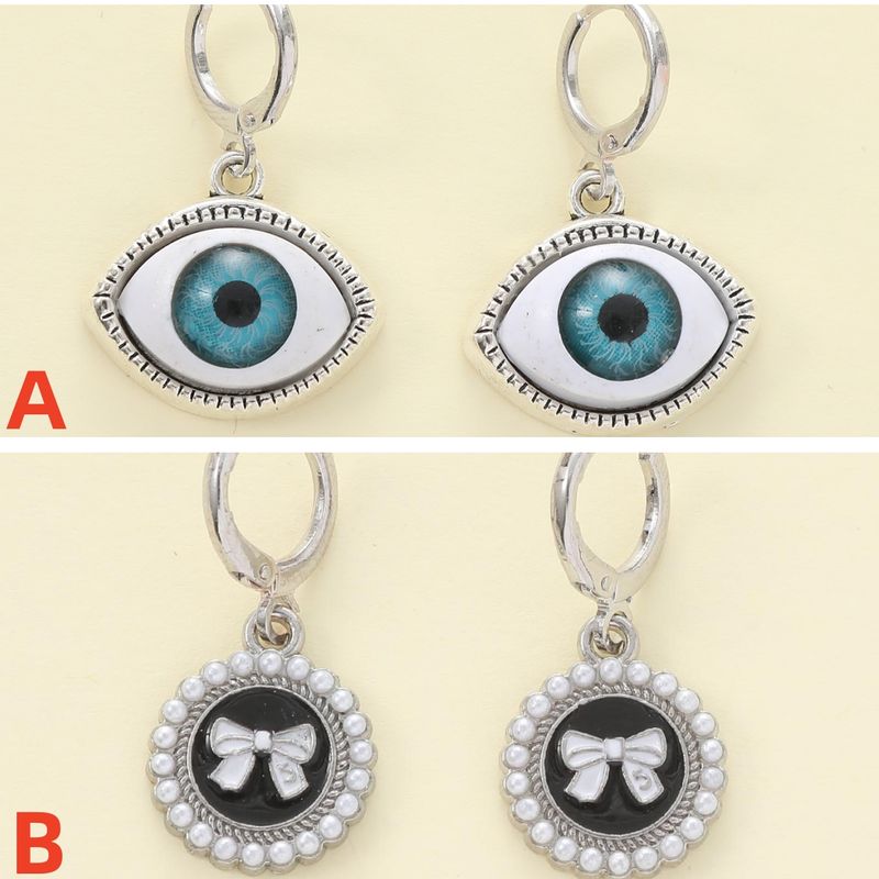 1 Paar Lässig Einfacher Stil Teufels Auge Bogenknoten Asymmetrisch Zinklegierung Künstliche Perlen Tropfenohrringe