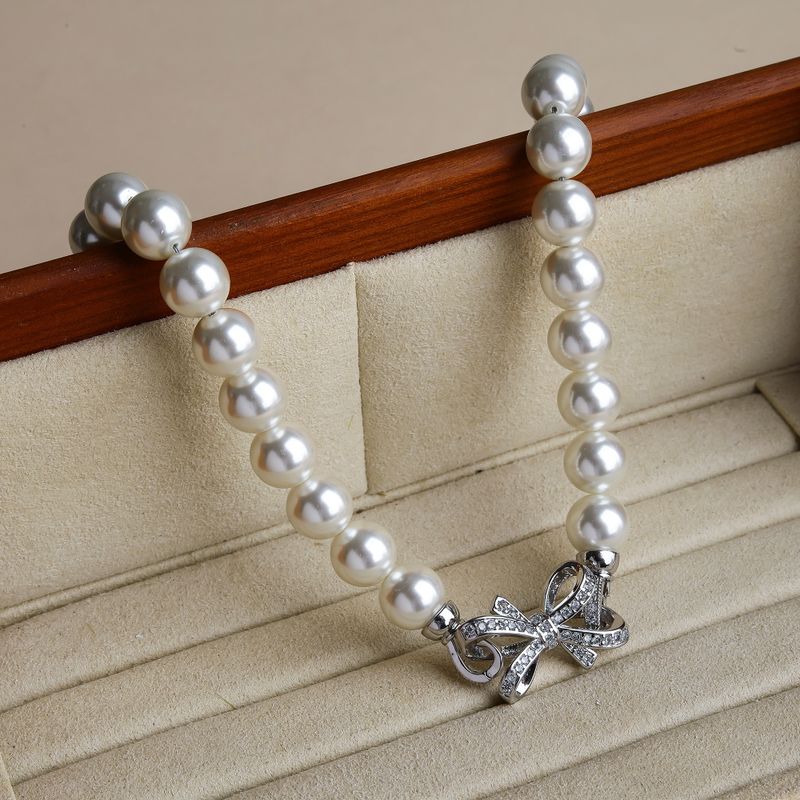 Großhandel Schmuck Elegant Glam Bogenknoten Künstliche Perle Kupfer Zirkon Inlay Halskette