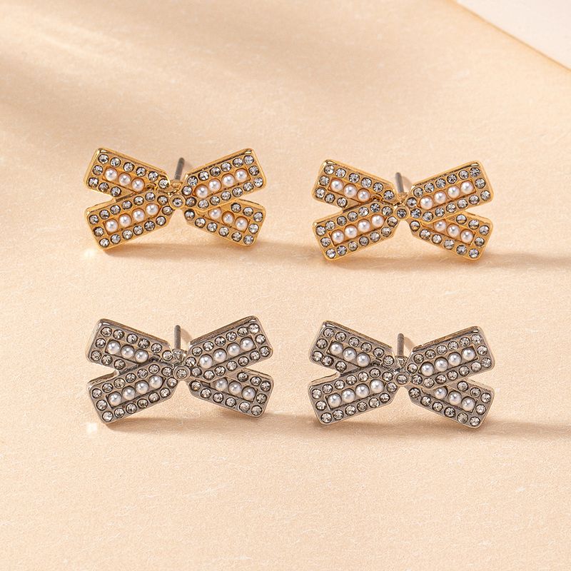 1 Paar Einfacher Stil Klassischer Stil Pendeln Bogenknoten Inlay Kunststoff Zinklegierung Künstliche Perlen Strasssteine Ohrstecker