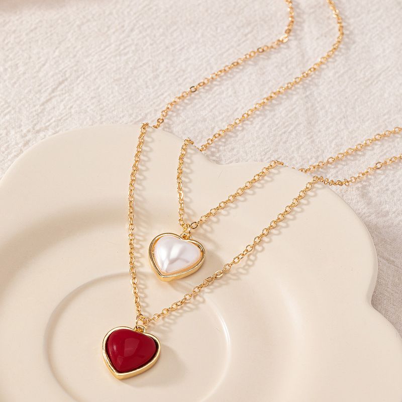 Großhandel Schmuck Elegant Dame Moderner Stil Herzform Kunststoff Zinklegierung Künstliche Perlen Inlay Halskette Mit Anhänger