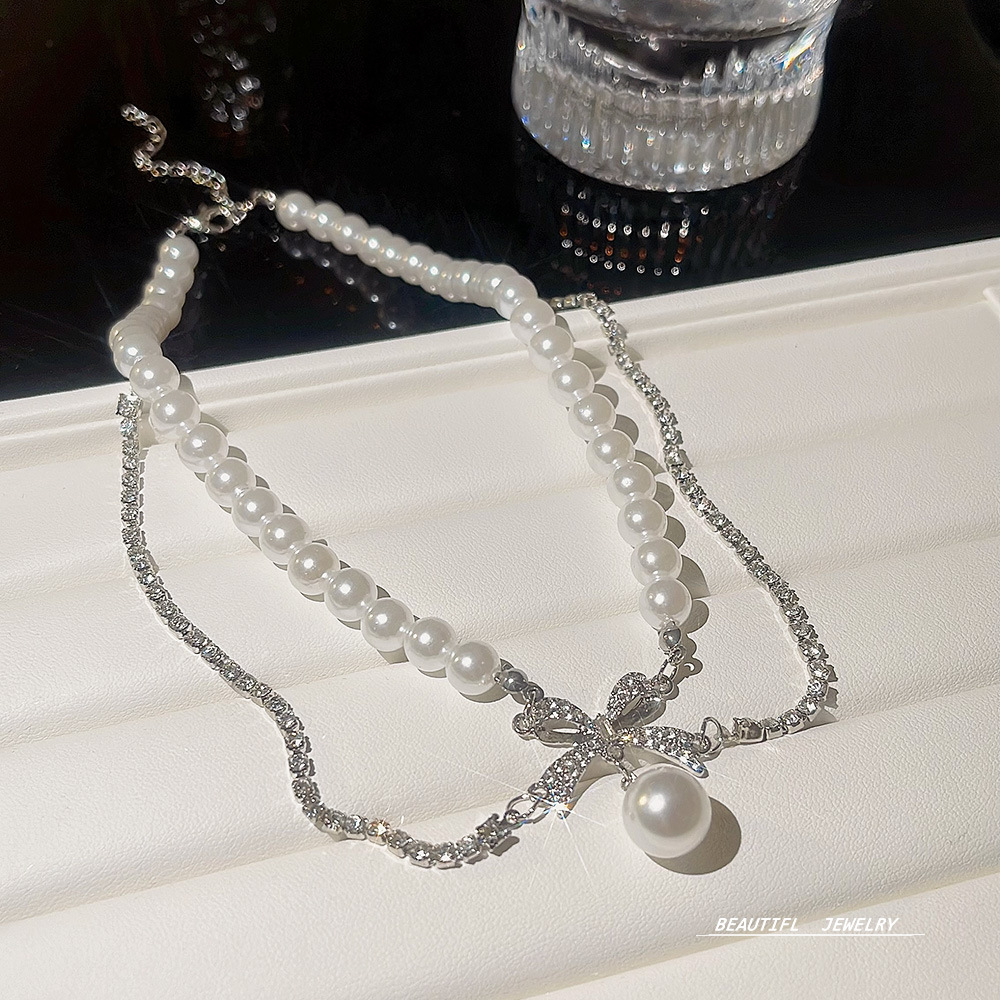 Großhandel Einfacher Stil Pendeln Bogenknoten Perlmutt Titan Stahl Perlen Geschichtete Halskette display picture 2