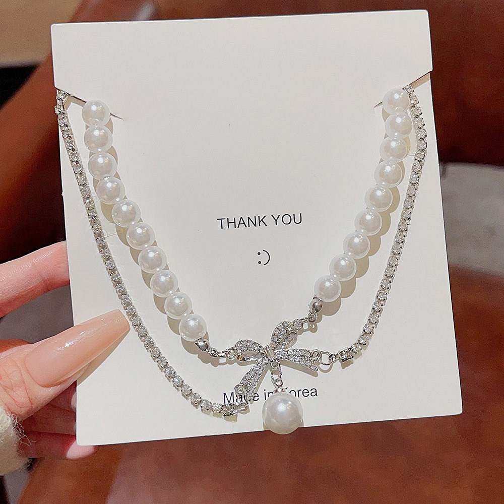 Großhandel Einfacher Stil Pendeln Bogenknoten Perlmutt Titan Stahl Perlen Geschichtete Halskette display picture 1