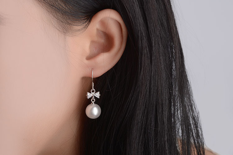 1 Pair Elegant Bow Knot Plating Inlay Copper Artificial Pearls Zircon White Gold Plated Drop Earrings display picture 1