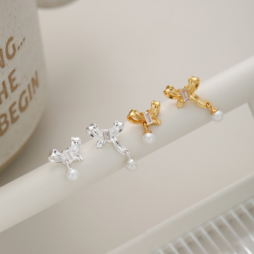 1 Pair Sweet Simple Style Bow Knot Hollow Out Inlay Sterling Silver Pearl Zircon Ear Studs display picture 6