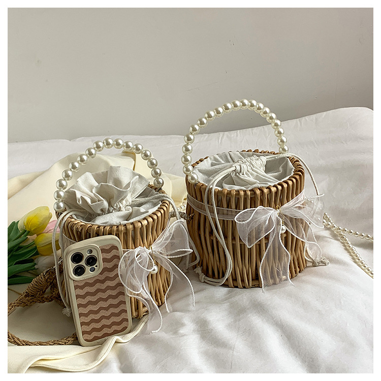 Women's Small Rattan Solid Color Vacation Beach Pearls Weave Bowknot Cylindrical String Straw Bag display picture 11